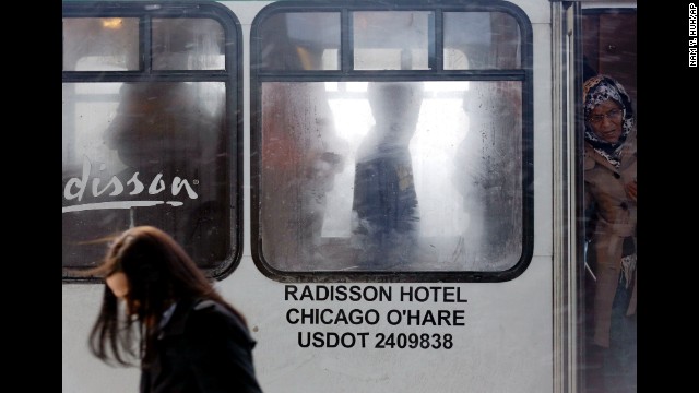 Travelers get off a shuttle bus at Chicago O'Hare International Airport on January 5.