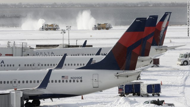 Snowplows clear snow from one of the runways January 3 at John F. Kennedy International Airport in New York City.