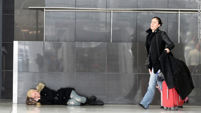 A woman sleeps on the floor of New York's JFK Airport on January 3.