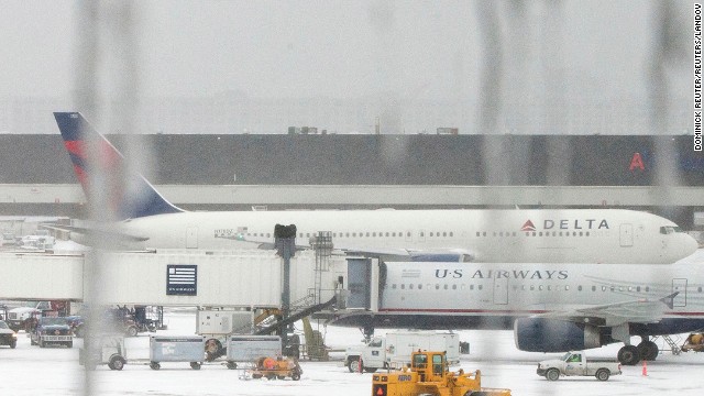 Icicles hang from a window looking onto airplanes at Logan International Airport in Boston on January 2.