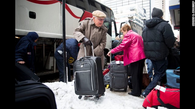 Passengers unload their luggage at Chicago's Union Station after their Amtrak train became stuck in snow drifts on Tuesday, January 7.