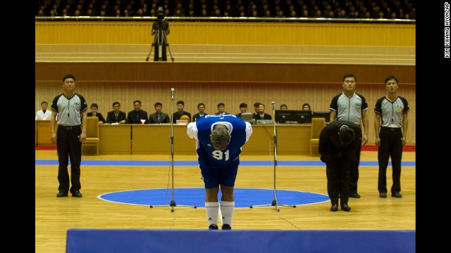 Rodman bows to Kim, seated above in the stands, before the basketball game on January 8.