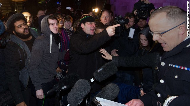 A crowd angry at the inquest verdict tries to shout down Police Assistant Commissioner Mark Rowley as he speaks to reporters.