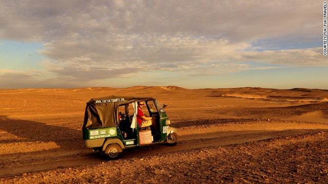Using makeshift wood planks and spades, Nick Gough and Richard Sears learned how to free their tuk tuk when it got stuck in the sand. Egypt was one of the toughest countries to bring a tuk tuk into, says Gough. 