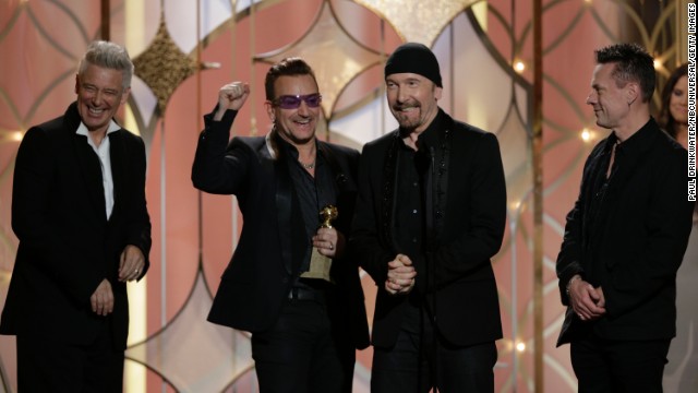 Adam Clayton, Bono, The Edge and Larry Mullen Jr. of U2 accept the award for best original song. The song "Ordinary Love" was produced by Danger Mouse and is from the film "Mandela: Long Walk to Freedom."