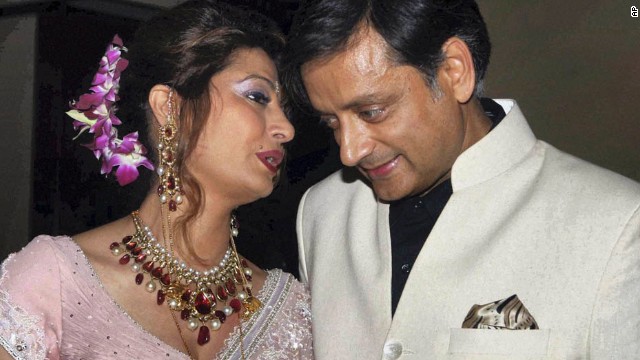 Tharoor listens to his wife at their wedding reception in New Delhi on September 4, 2010. 