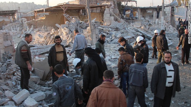 Syrians search for survivors after a building collapsed following alleged airstrikes by Syrian government forces on January 18 in Aleppo. 