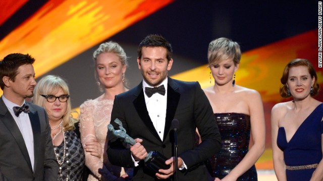 Bradley Cooper and the cast of "American Hustle" accept the award for outstanding performance by a cast in a motion picture. Cooper, practically yelling his approval, paid tribute to director David O. Russell for the film.