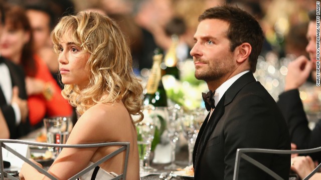 Model Suki Waterhouse and Bradley Cooper sit in the audience.