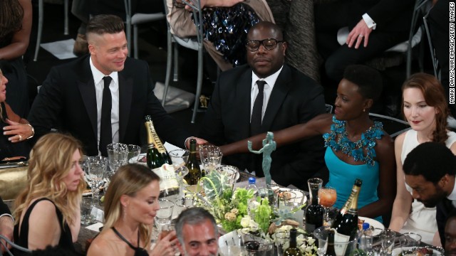 From left, Brad Pitt, Steve McQueen and Lupita Nyong'o at their table during the show.