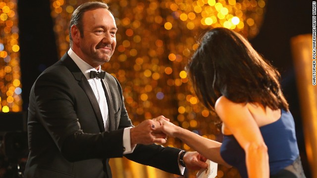 Kevin Spacey helps Julia Louis-Dreyfus onstage. She won best female actor in a comedy series for "Veep."