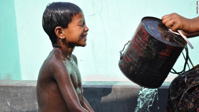 A young boy takes a bath at a public water stand post near Uttar Bishli, Bangladesh.