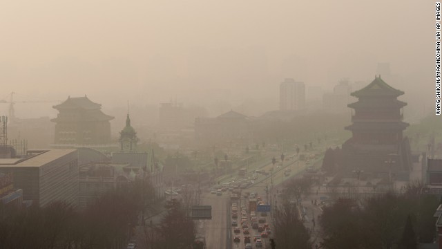 Vehicles move slowly through heavy smog in Beijing on Thursday, January 16. China's manufacturing of exports generates pollution that harms air quality -- not only in Asia but also all the way across the Pacific Ocean in the <a href='http://www.cnn.com/2014/01/20/health/pollution-china-pnas/index.html'>Western United States</a>, according to a new study. 