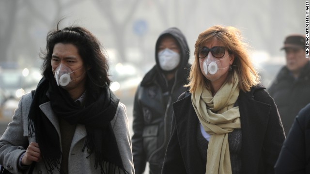 People use face masks during their commute in Beijing on January 16. The Chinese government is trying to control the number of new vehicle registrations this year in some cities to help improve air quality, <a href='http://money.cnn.com/2014/01/20/autos/china-autos-pollution/'>CNNMoney reports</a>.