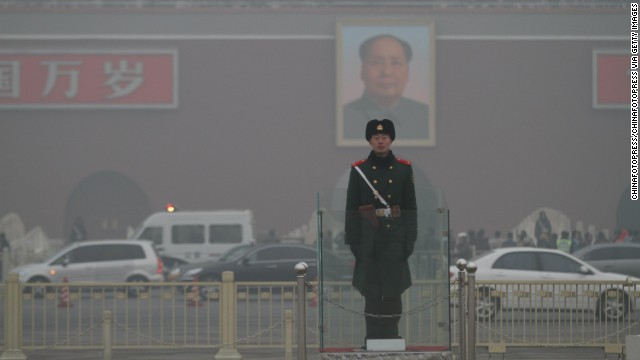 A police officer stands guard in Beijing's Tiananmen Square on January 16. The co-author of a new study recommends increasing the efficiency of manufacturing processes and re-examining energy production to decrease pollution in China.