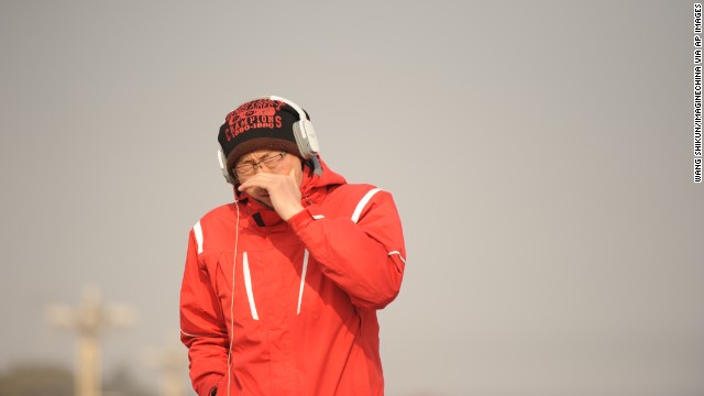 A pedestrian covers his mouth and nose in Beijing's Tiananmen Square on January 16.