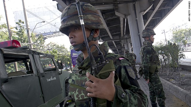 Thai soldiers stand guard at an intersection in Bangkok as the government calls a state of emergency 