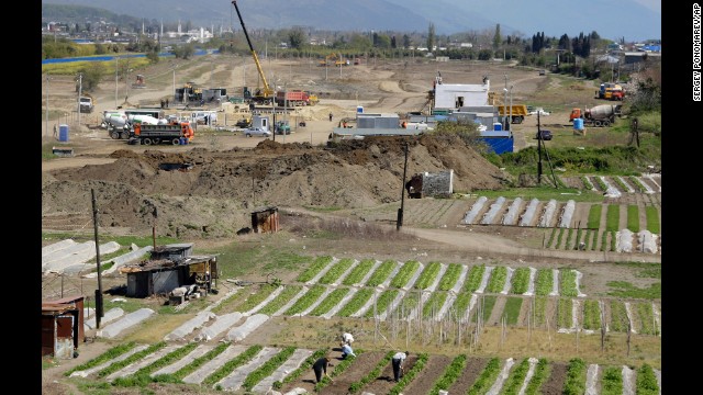 People work on their vegetable gardens near the construction site of the Olympic facilities in the Imeretinskaya Valley in April 2009.