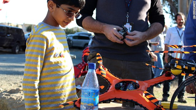 A young drone fan checks out the Game of Drones damage-resistant flying vehicle, which can withstand paintball hits, shotgun blasts and baseball bats. 