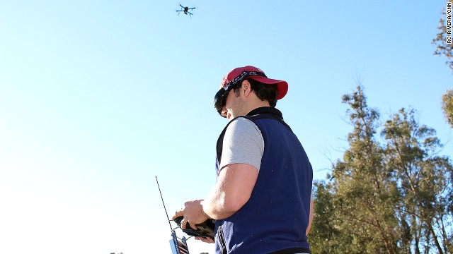 3D Robotics employee Pablo Lema views live video streamed from the drone above his head. The first-person view is displayed on his goggles, while he steers the device with a hand-held controller.