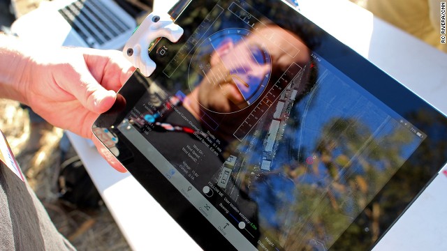 Fighting Walrus co-founder Andy Brown demonstrates his company's iPad accessory (mounted on the left side of the tablet), a $129 device for controlling and communicating with drones. 