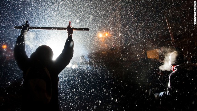 Protesters clash with police in Kiev as snow falls on January 22.