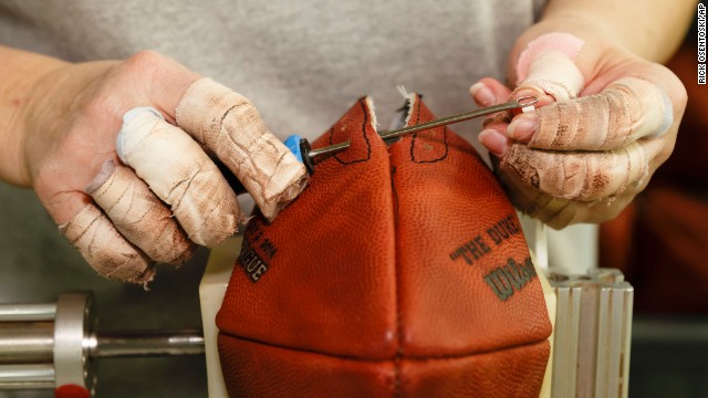 Donna Connelly threads the laces of an official Super Bowl game ball at Wilson Sporting Goods in Ada, Ohio, on Monday, January 20.