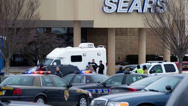 Authorities and emergency vehicles gather outside the mall. 