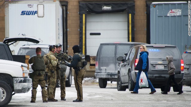 Maryland State Police officers gear up as civilians depart Columbia Mall after the shooting. 