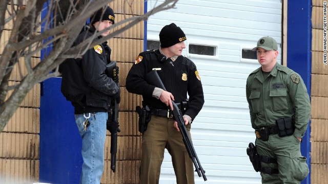 Police secure an entrance to a Sears store at the mall. 