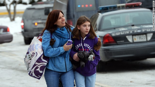 Two shoppers leave the mall after the shooting. 