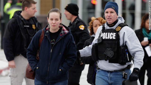 Police escort people from the mall as they assist in evacuations. 