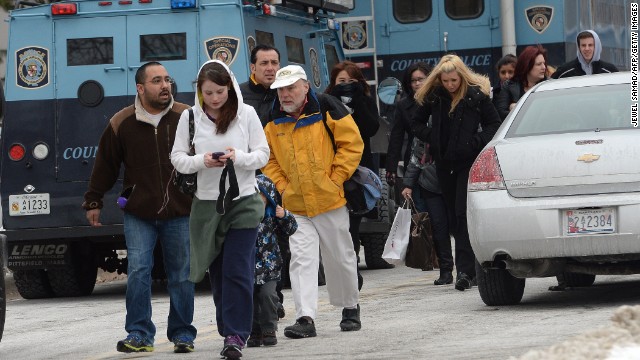 People leave the mall as it is evacuated after the shooting. 