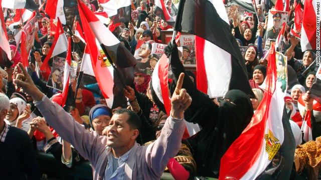 Egyptians backing General Abdel Fattah al-Sisi wave national flags during a rally in Cairo's Tahrir Square on January 25, 2014. 