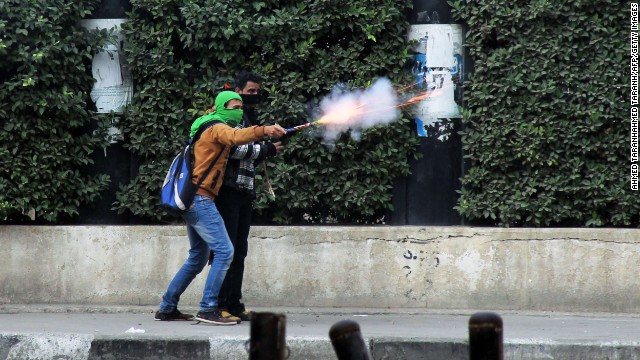 A Muslim Brotherhood supporter aims fireworks at pro-military demonstrators clashes in Cairo.