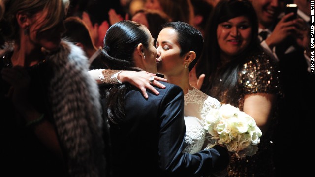 Audience members participate in a mass wedding during the Macklemore and Lewis song "Same Love," which advocates legalizing same-sex marriage.