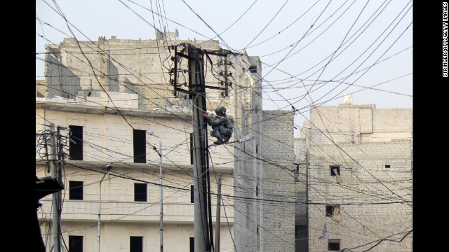 A man tries to fix electrical wires in a neighborhood of Aleppo, Syria, on January 27.