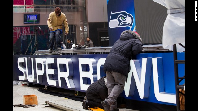 Workers put together a stage structure for Super Bowl activities in Times Square on Monday, January 27.