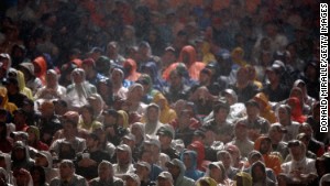 Fans sit in the rain as they watch Super Bowl XLI between the Chicago Bears and the Indianapolis Colts on February 4, 2007 at Dolphin Stadium in Miami Gardens, Florida. 