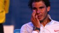 Rafael Nadal of Spain wipes his face after losing his men's final match against Stanislas Wawrinka of Switzerland during day 14 of the 2014 Australian Open at Melbourne Park on January 26, 2014 in Melbourne, Australia. 