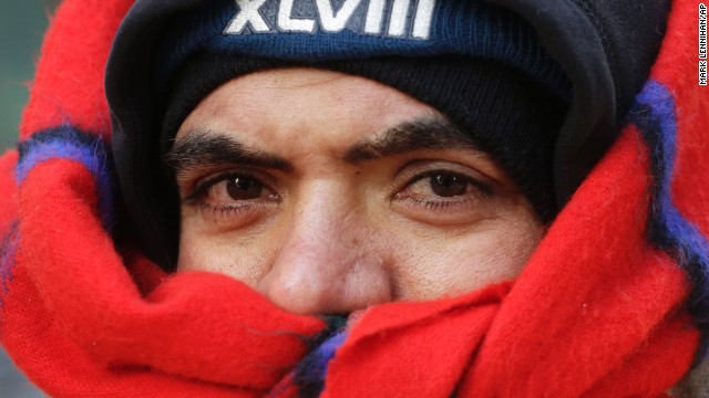 A security guard is bundled up while watching over Super Bowl Boulevard on January 28.