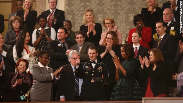 US Army Ranger Sgt. First Class Cory Remsburg, injured while serving in Afghanistan, acknowledges the crowd during a standing ovation for him as President Barack Obama delivers his State of the Union speech.