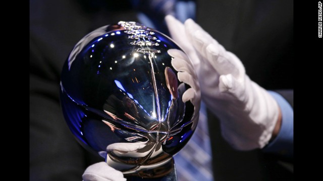 A man sets up the Lombardi Trophy for display before the head coaches' news conference.