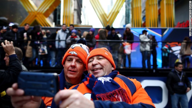 Denver Broncos fans photograph themselves during Super Bowl festivities in New York's Times Square on Friday, January 31. 