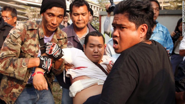 An injured pro-government supporter is carried to a hospital during clashes with anti-government protesters in Bangkok, Thailand, on Saturday, February 1. Gunshots were fired during a confrontation injuring at least six people. 