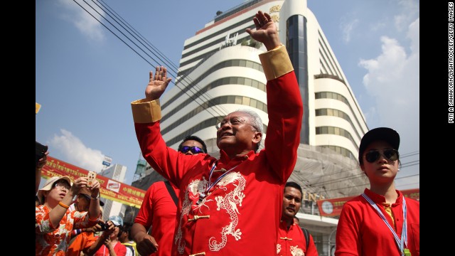 Anti-government protest leader Suthep Thaugsuban cheers during a march through Bangkok's Chinatown. 