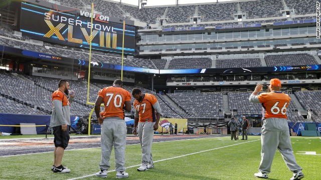 Denver Broncos players Louis Vasquez, left, Vinston Painter, Winston Justice, and Manny Ramirez look around MetLife Stadium before the team's walk-through on February 1.