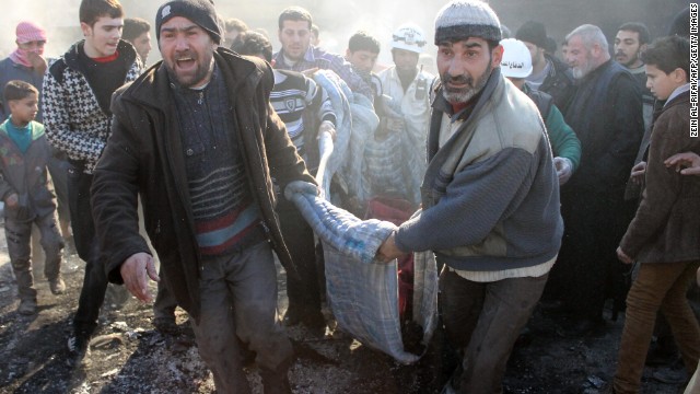 Syrians carry a dead body following an airstrike on February 1.