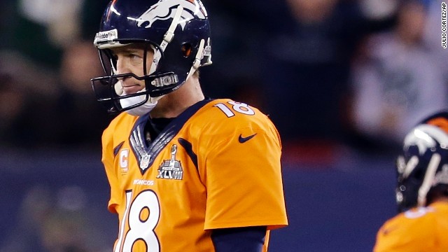 Manning (18) cuts a dejected figure after he walks off the field after being intercepted.