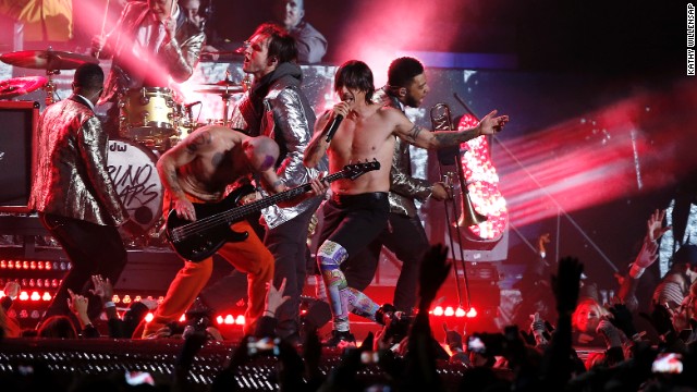 The Red Hot Chili Peppers join Mars on stage for a rendition of "Give It Away."